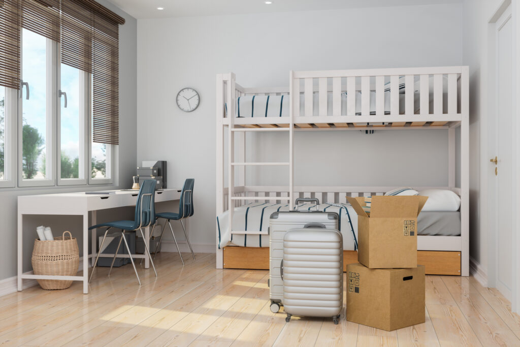 modern college dorm room with cardboard boxes and luggages